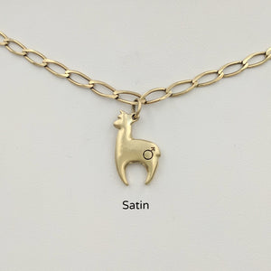 Alpaca Huacaya hand-made 14K yellow gold crescent shaped charm with a gender accent stamp; satin finish