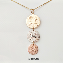 Load image into Gallery viewer, Side 1 of the Alpaca or Llama Reversible Tri-Coin Drop Pendant -The Largest top coin is 14K Yellow Gold with a pronking animal and sun accent, the middle coin is 14K White Gold with a pronking animal and a moon accent, the smallest coin is 14K Rose Gold with a pronking animal and a heart accent