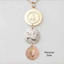 Load image into Gallery viewer, Side 2 of the Alpaca or Llama Reversible Tri-Coin Drop Pendant -The Largest top coin is 14K Yellow Gold with a Peace Sign, the middle coin is 14K White Gold with a Dove, the smallest coin is 14K Rose Gold a heart